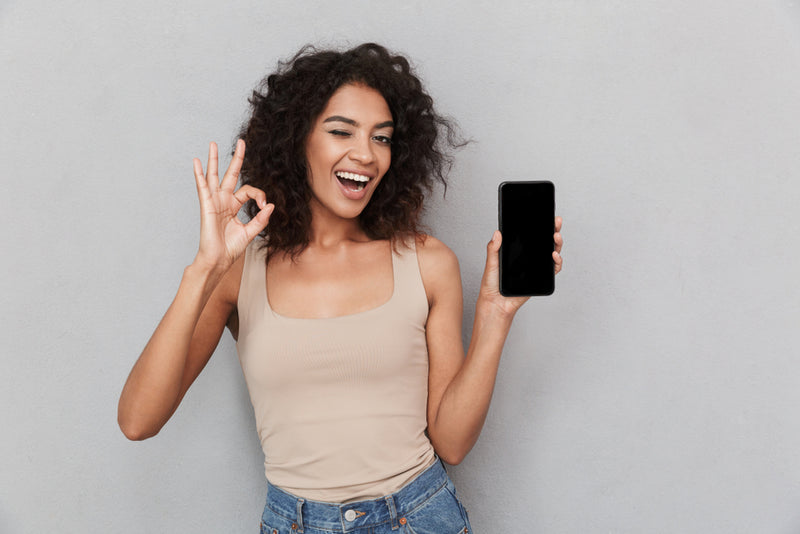 woman-holding-smartphone-ok-sign